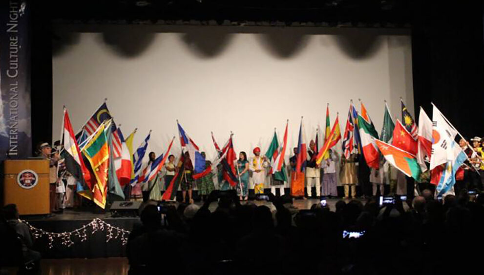 International students hold their country flags