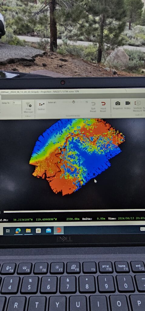 laptop with liddar technology showing the differences in elevation of a woodsy area